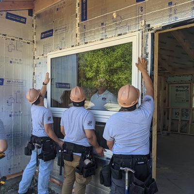 Soldiers from Fort Riley's HBI Program install windows at the home build at 229 12th Street in Ogden.